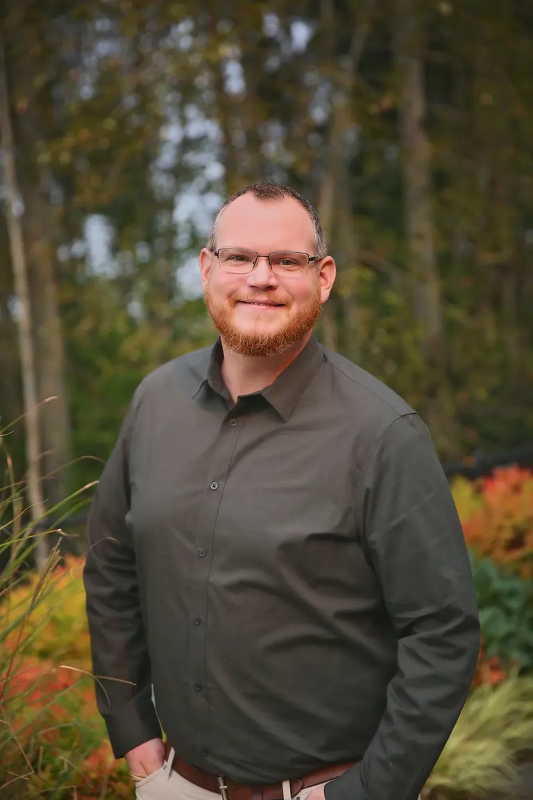 Joe Butler standing outdoors in a Pacific Northwest garden